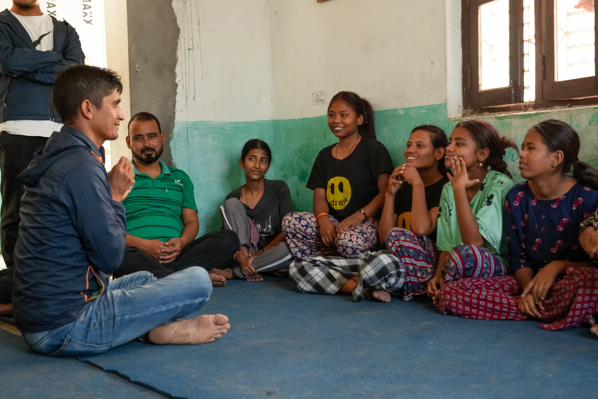 Deaf students at RHERI sitting in a circle during a sign language lesson with their teachers